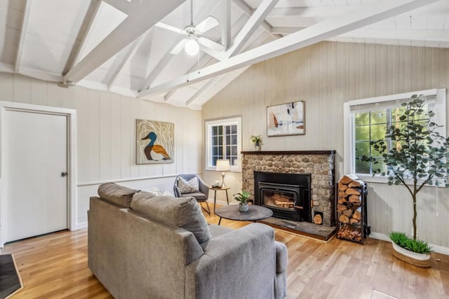 living room featuring vaulted ceiling with beams, ceiling fan, and light hardwood / wood-style flooring