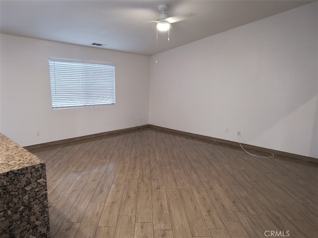 unfurnished room with ceiling fan and light wood-type flooring