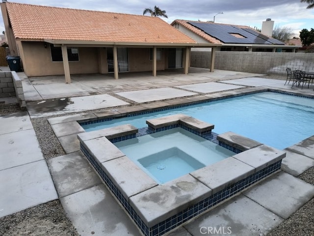 view of pool with a patio area and an in ground hot tub