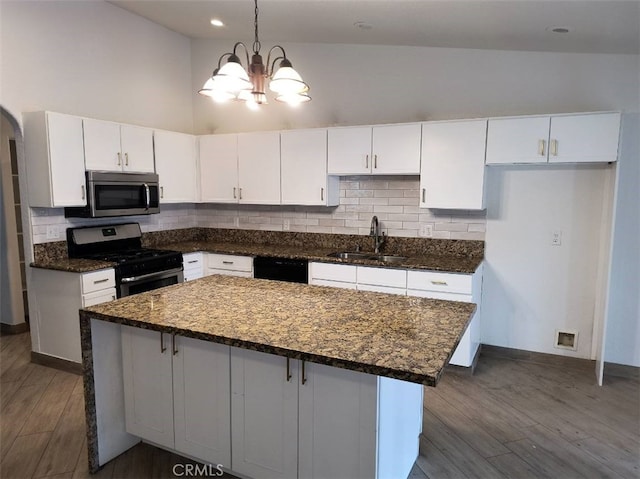 kitchen featuring white cabinetry, sink, a kitchen island, and appliances with stainless steel finishes