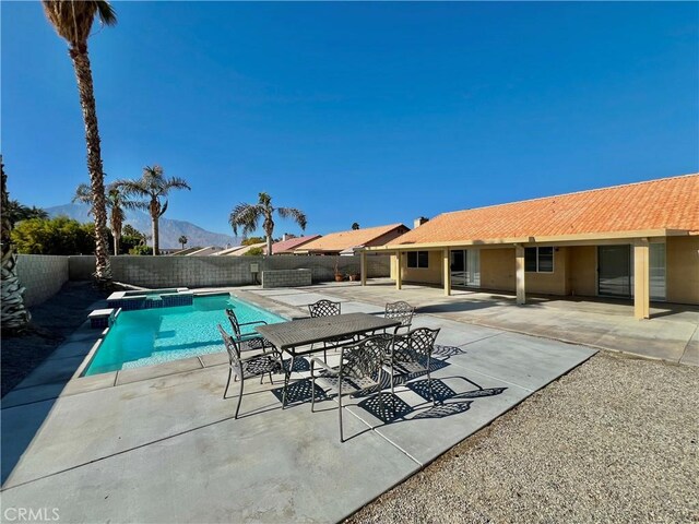 view of swimming pool with a patio and a mountain view