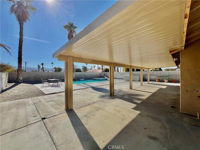 view of patio with a fenced in pool