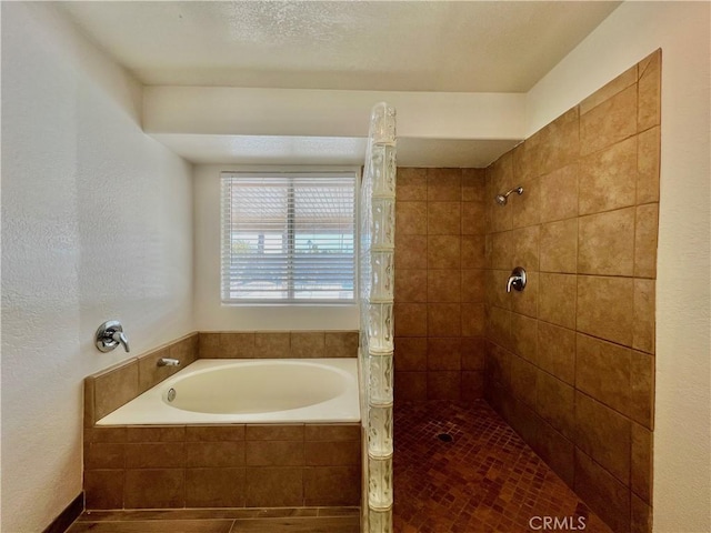 bathroom featuring shower with separate bathtub