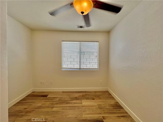 empty room featuring light hardwood / wood-style floors and ceiling fan