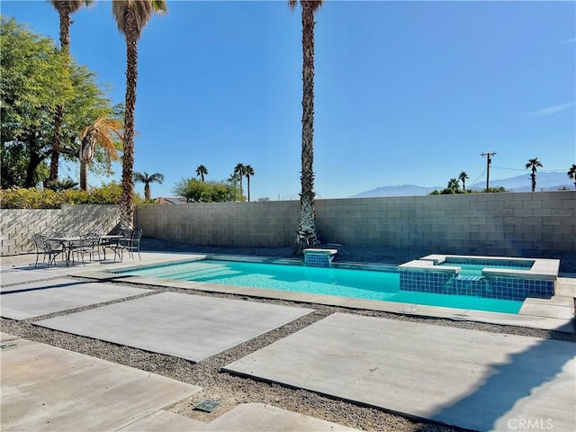 view of pool with a patio area and an in ground hot tub