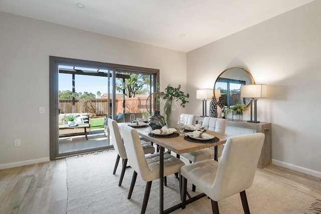 dining room with plenty of natural light and light hardwood / wood-style flooring