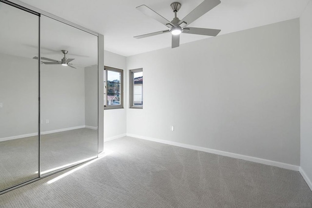 unfurnished bedroom featuring carpet floors, ceiling fan, and a closet