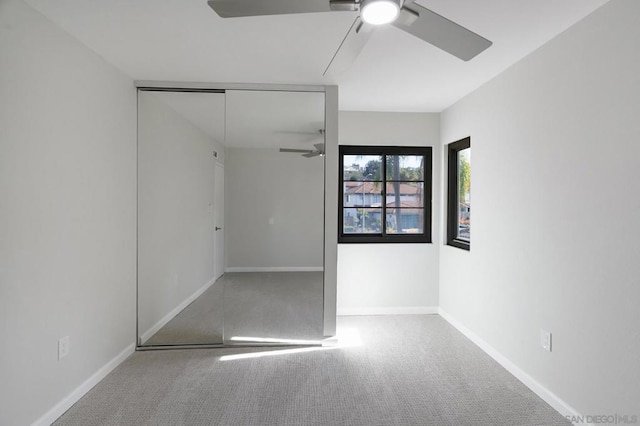 unfurnished bedroom with carpet floors, a closet, and ceiling fan