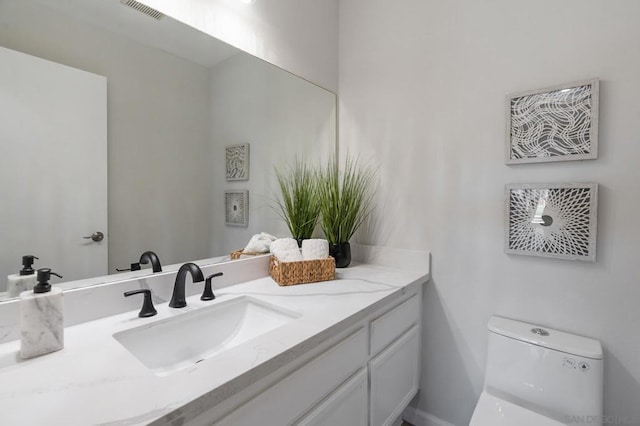 bathroom with vanity and toilet