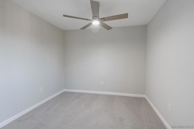 carpeted spare room featuring ceiling fan