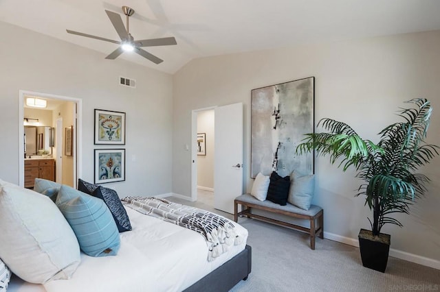 carpeted bedroom with ensuite bathroom, lofted ceiling, and ceiling fan