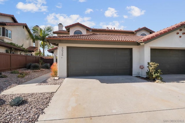 mediterranean / spanish-style house with a garage