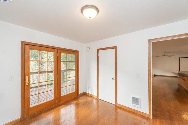 unfurnished room with wood-type flooring