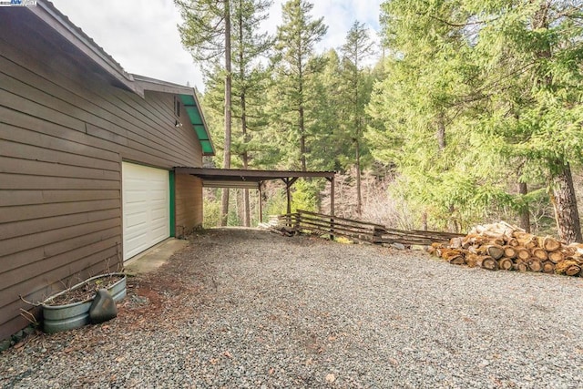 view of yard with a garage and a carport