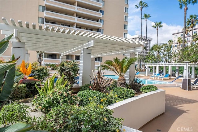 view of property's community with a patio, a swimming pool, and a pergola