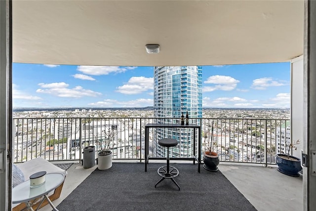 balcony featuring a water view and a beach view