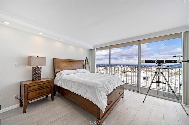 bedroom with floor to ceiling windows and access to exterior