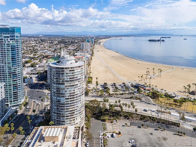 drone / aerial view featuring a water view and a view of the beach