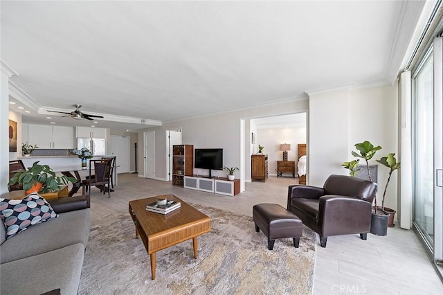 living room featuring ceiling fan and ornamental molding