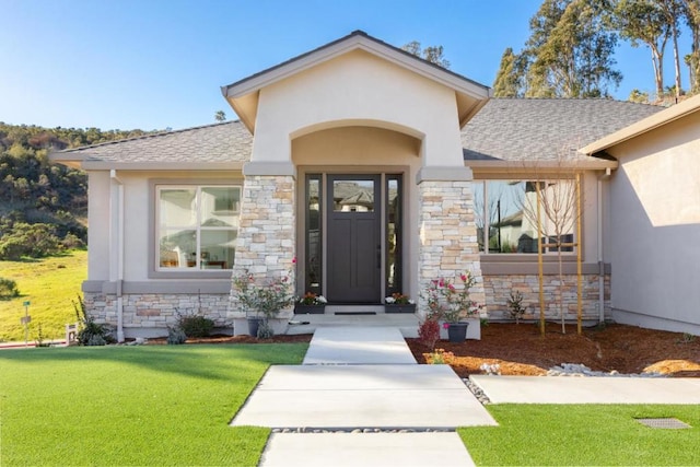 property entrance with a lawn