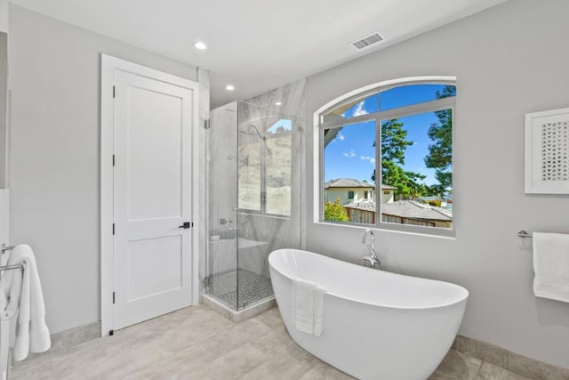 bathroom featuring plus walk in shower