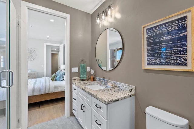 bathroom featuring vanity, tile patterned floors, and toilet