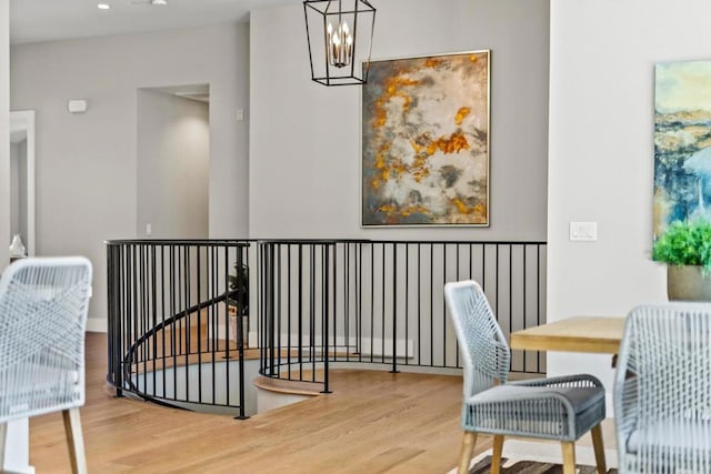 interior space with a notable chandelier and hardwood / wood-style flooring