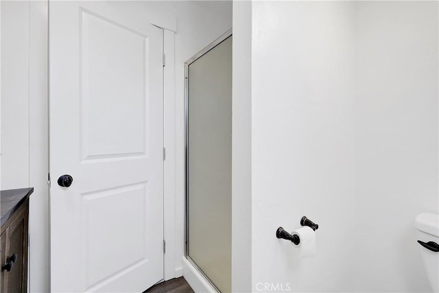 bathroom featuring toilet and walk in shower