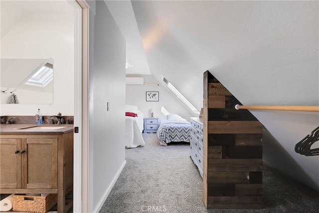 bedroom featuring vaulted ceiling, sink, and light colored carpet