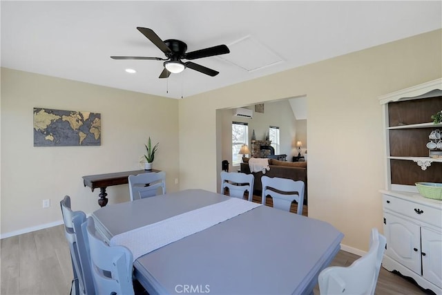 dining area with ceiling fan and light wood-type flooring