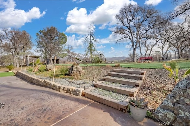 view of community featuring a yard and a mountain view