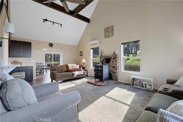 carpeted living room featuring ceiling fan, high vaulted ceiling, an AC wall unit, beamed ceiling, and a wood stove