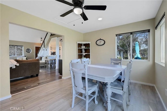 dining area with ceiling fan and light hardwood / wood-style flooring