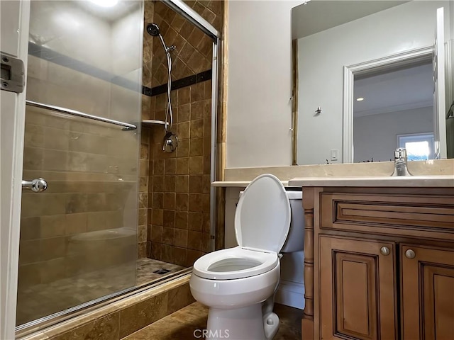 bathroom with vanity, a shower with shower door, and toilet