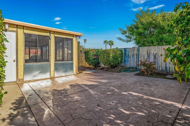 view of patio featuring a sunroom