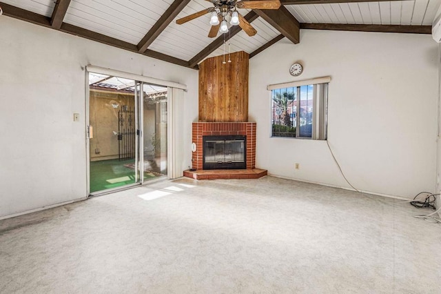 unfurnished living room featuring ceiling fan, a fireplace, lofted ceiling with beams, and carpet