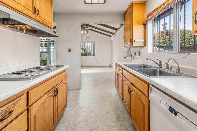 kitchen with lofted ceiling with beams, dishwasher, sink, wood ceiling, and cooktop