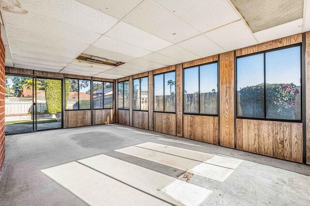 unfurnished sunroom featuring a paneled ceiling