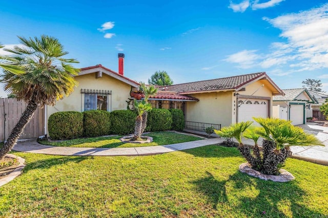 view of front of house with a garage and a front yard