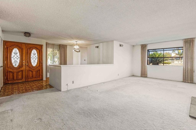 entryway featuring carpet floors and a textured ceiling