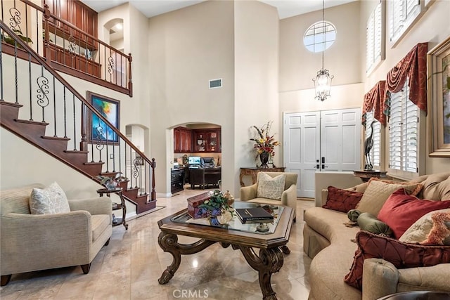 living room with plenty of natural light and a towering ceiling