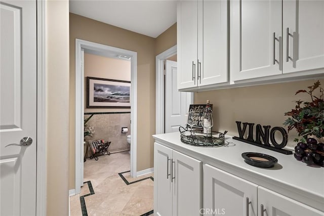 interior space featuring white cabinetry and light tile patterned flooring