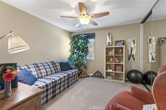 carpeted living room with ceiling fan