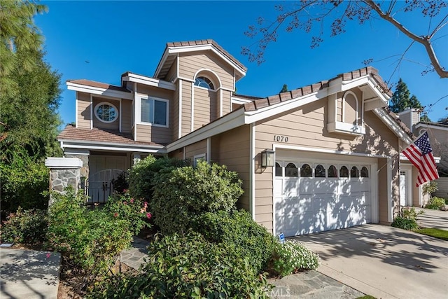 view of front of property with concrete driveway and an attached garage