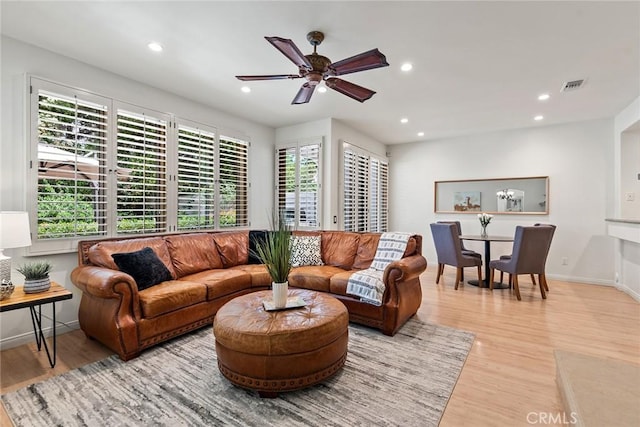 living area with light wood-style flooring, recessed lighting, baseboards, a ceiling fan, and visible vents