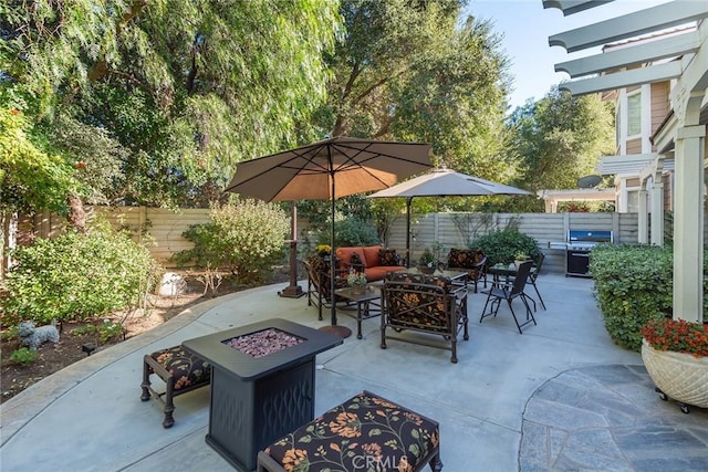 view of patio / terrace featuring grilling area, a fenced backyard, and an outdoor living space with a fire pit