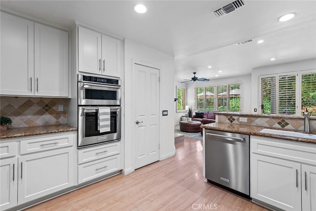 kitchen with recessed lighting, appliances with stainless steel finishes, a sink, and visible vents