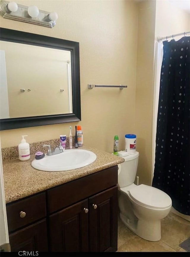 bathroom featuring vanity, tile patterned flooring, toilet, and a shower with shower curtain