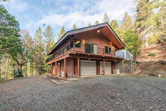 view of front of house featuring a garage and a deck