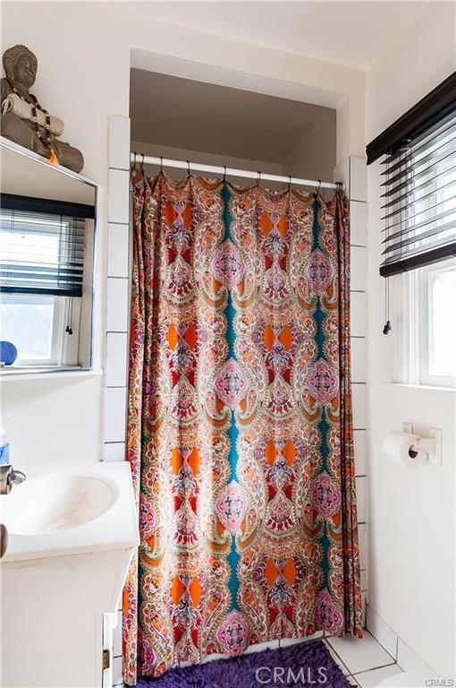 bathroom with tile patterned flooring and vanity